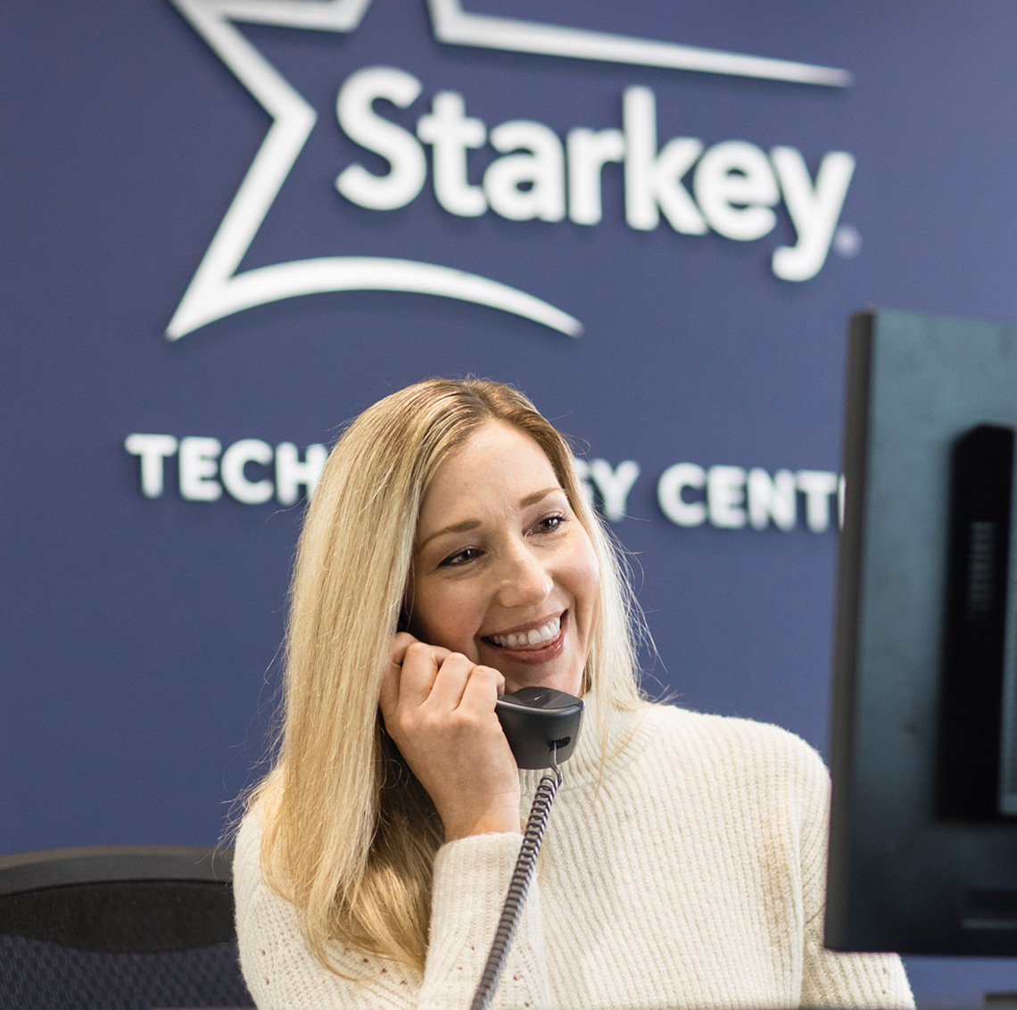 Female Starkey employee answering phone