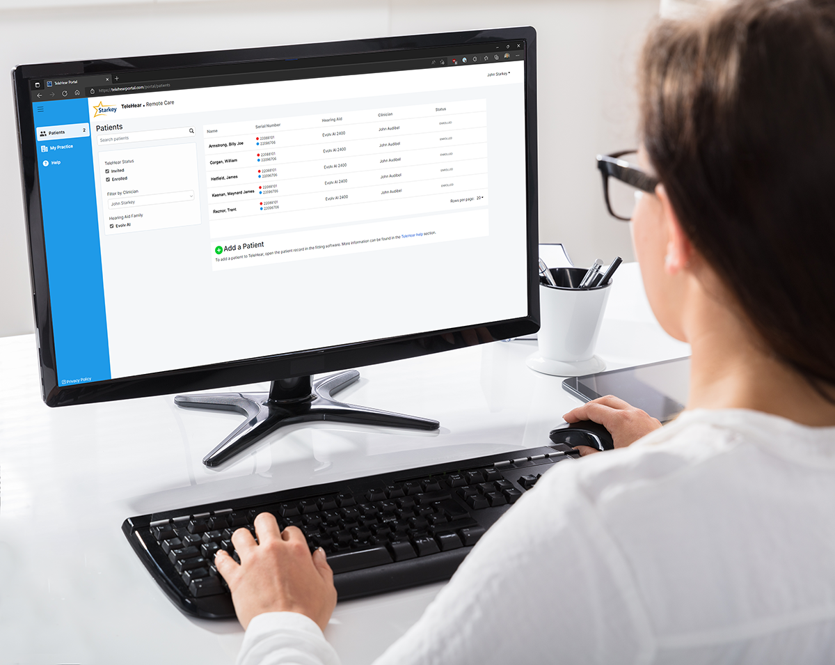 Professional viewing TeleHear dashboard on computer monitor