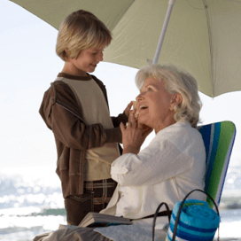 Starkey History 2007 - Woman and child on a beach under an umbrella
