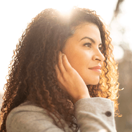 Starkey History 2020 - woman wearing glasses and a hearing aid