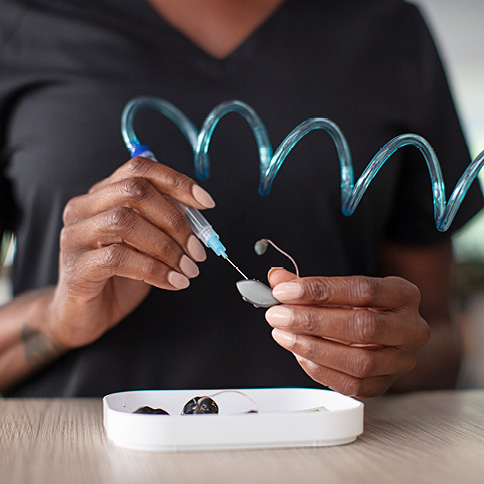 Woman working on hearing aid