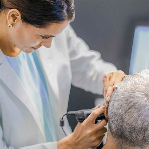Professional fitting a hearing aid.