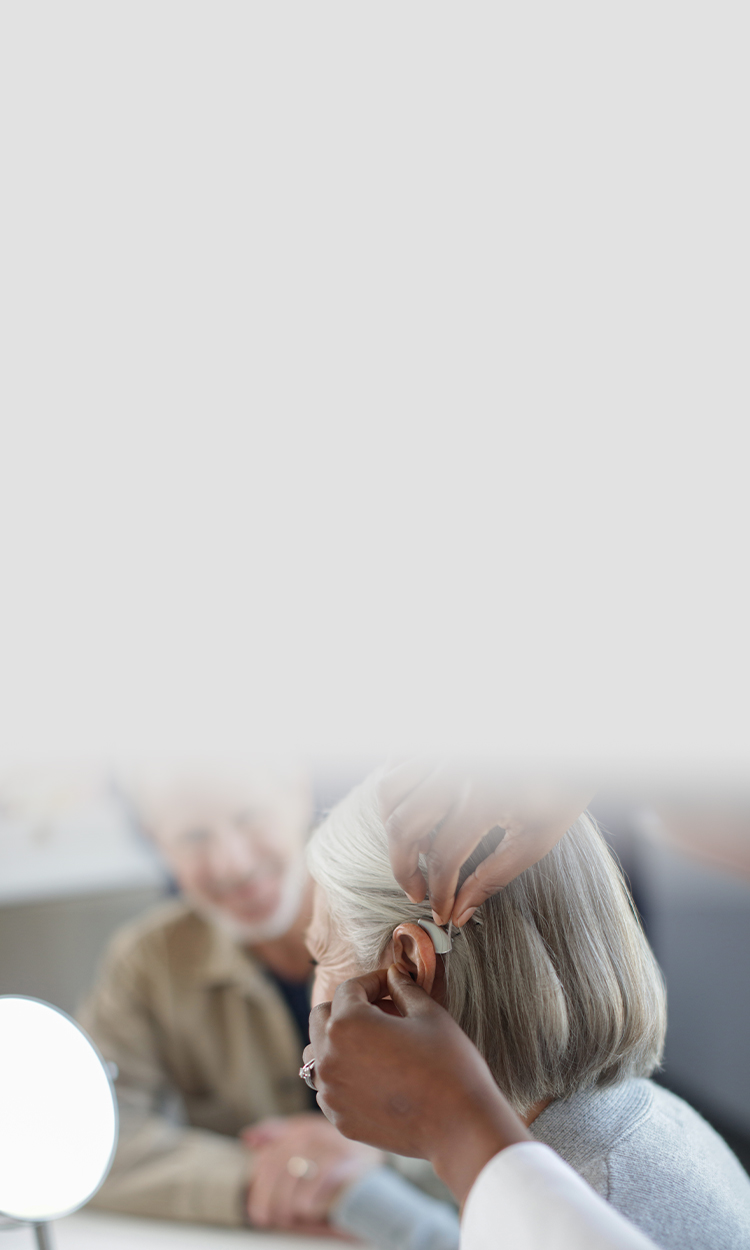 A woman being fit with a hearing aid