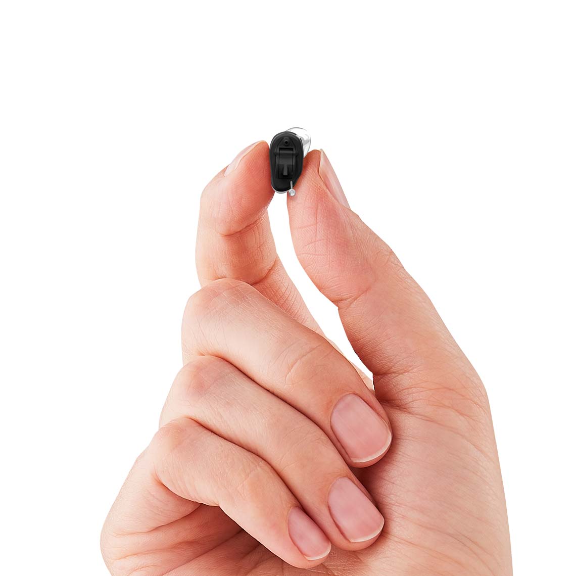 An CIC non-wireless hearing aid being held in a hand