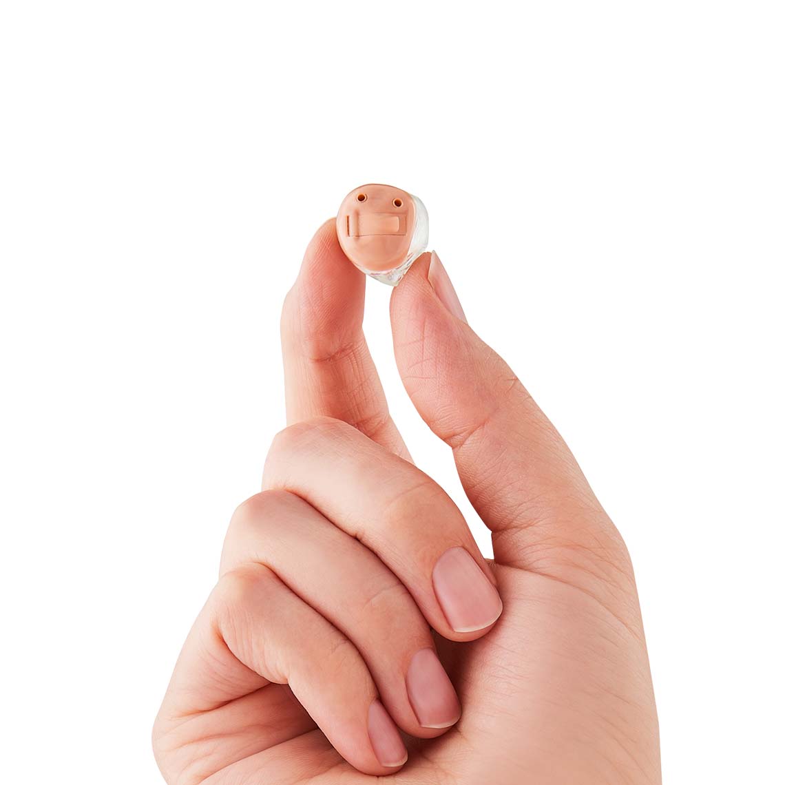 A hand holding a ITC hearing aid