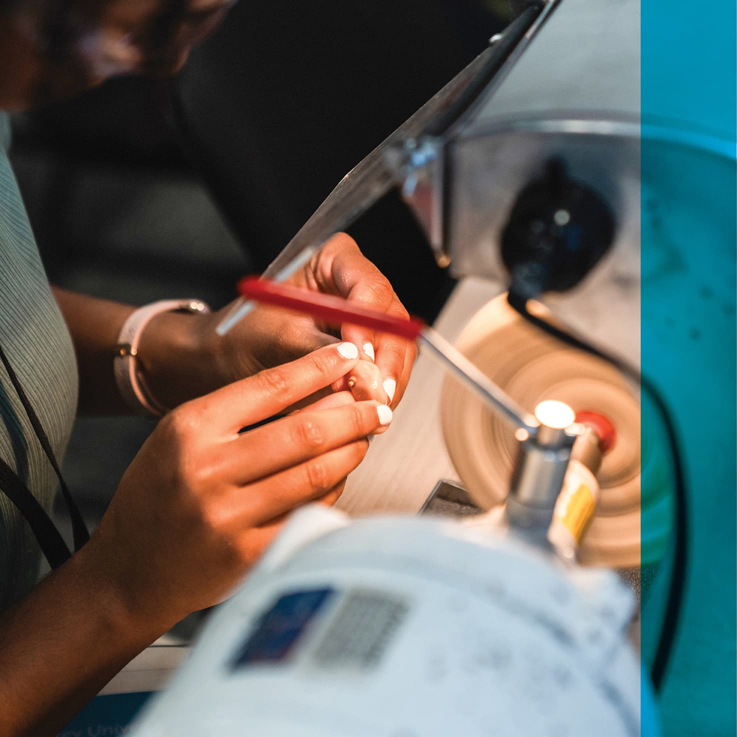 person polishing a hearing aid