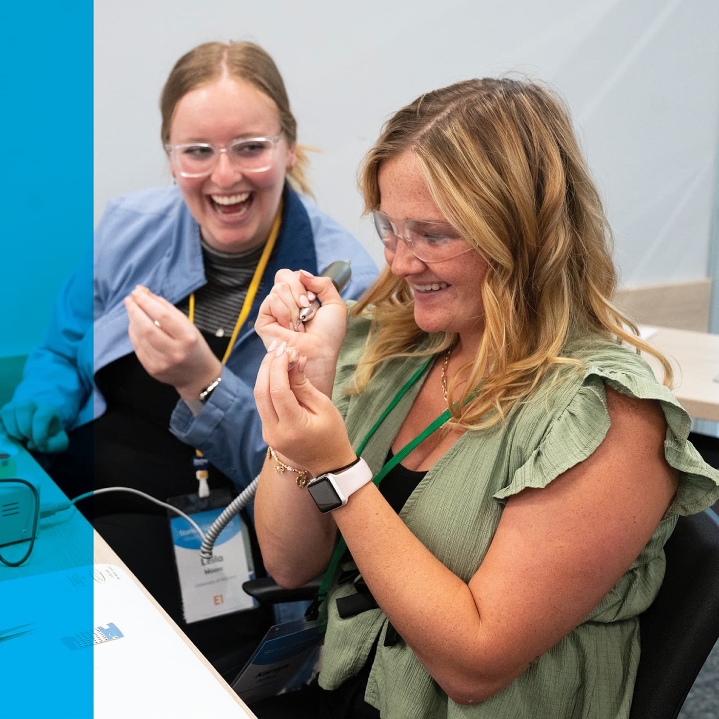 student learning to adjust a hearing aid with a teacher